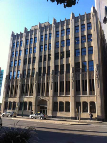 Built in 1931 and designed by local architect Alexander D. Melville, this building on Portage Avenue East was occupied by the Manitoba Government Telephones, later known as the Manitoba Telephone System. Its initials are carved into the facade of the building. In 2019, it became a municipally designated historic building.