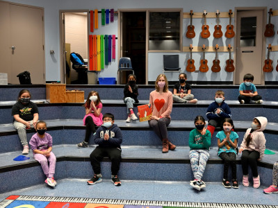 Katherine Mayba reads "the Opera Cat" and demonstrates some opera chops to students at James Nesbitt Community School for Reading Week.